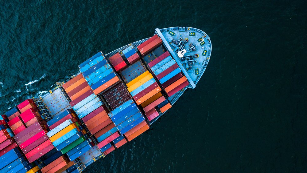 Imagem mostra um barco carregado de  contêiners, muito utilizado para a atividade econômica de importação e exportação